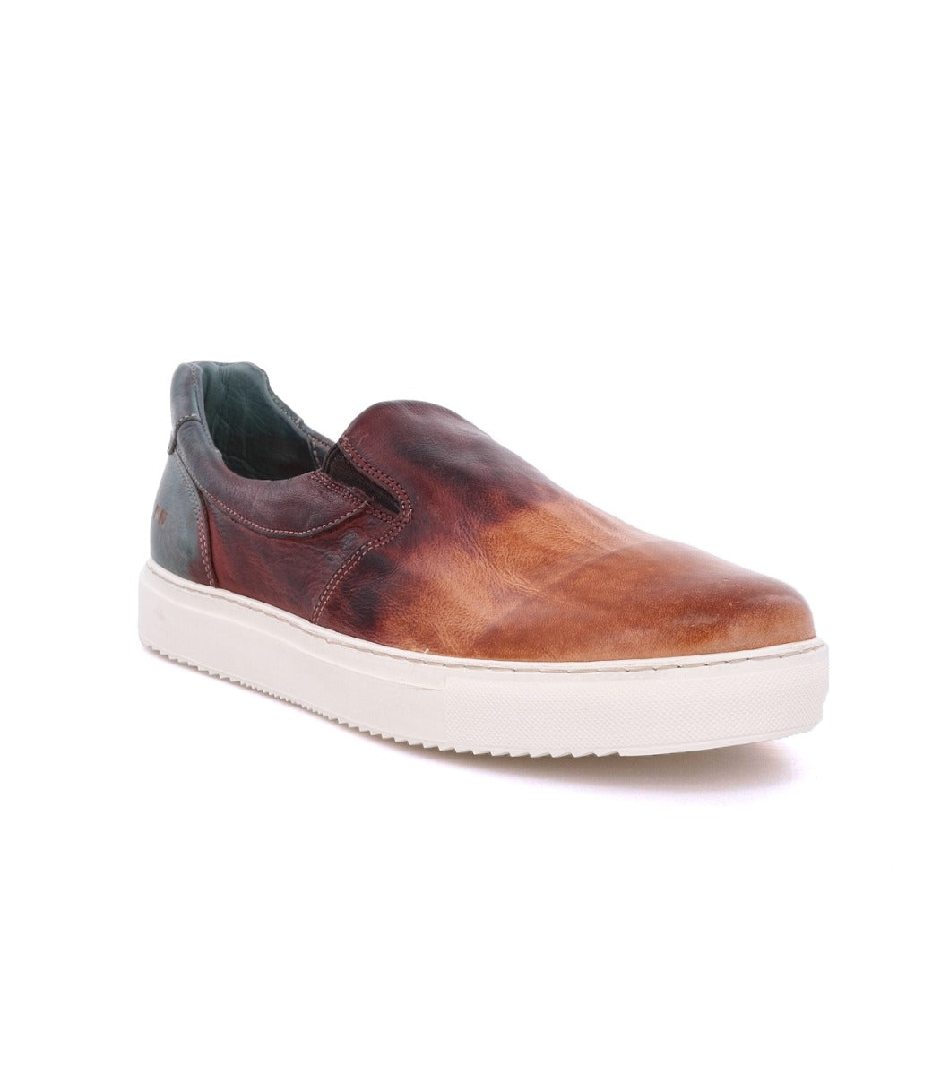 A men's slip on sneaker with a brown leather upper and white sole, the Bed Stu Harry.