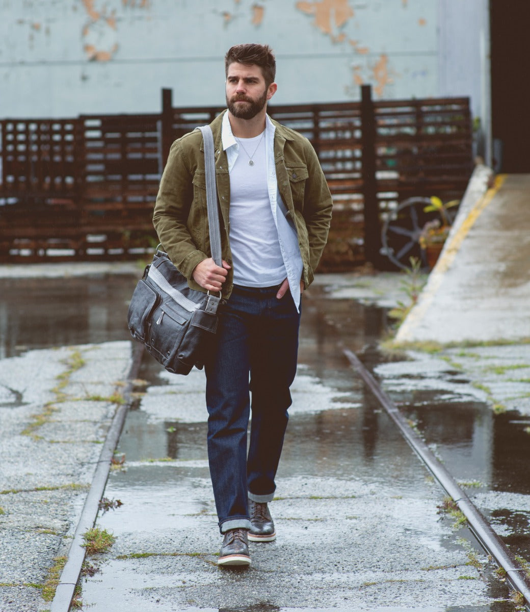 A man wearing a Bed Stu Hawkeye II messenger bag