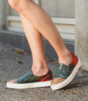 A woman wearing a pair of colorful slip on sneakers called Hermione by Bed Stu.
