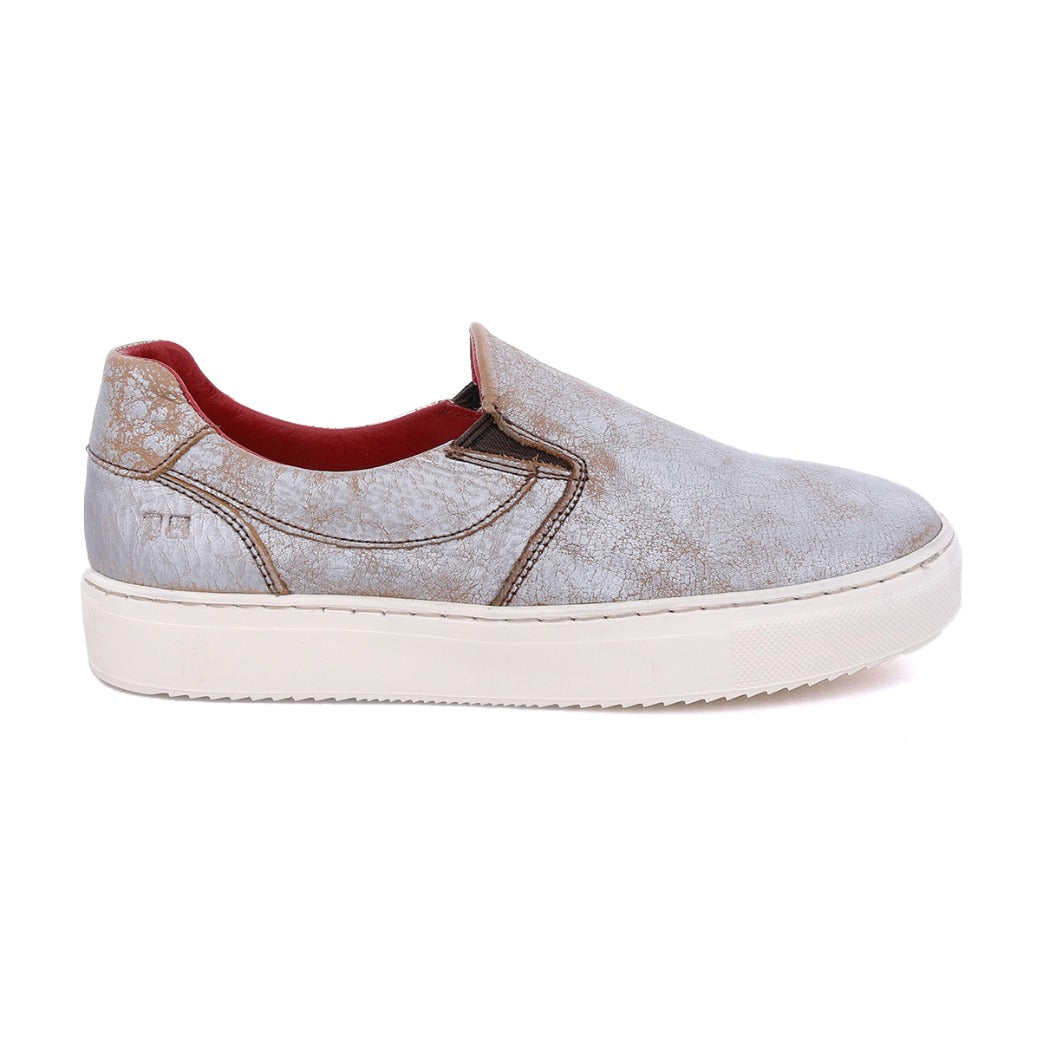 A grey slip on sneaker with a red sole named Hermione by Bed Stu.