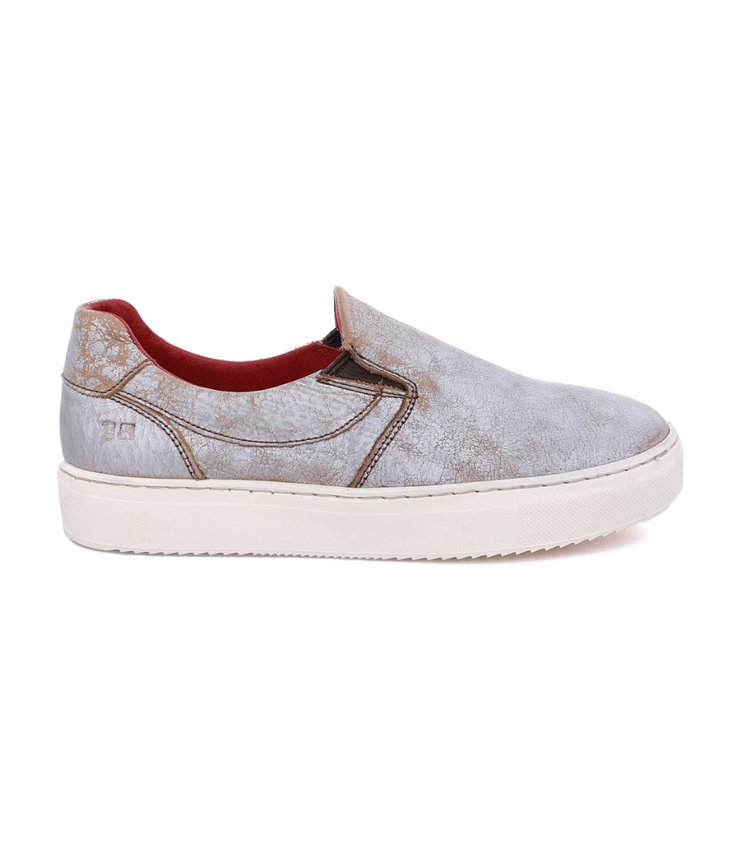 A grey slip on sneaker with a red sole named Hermione by Bed Stu.
