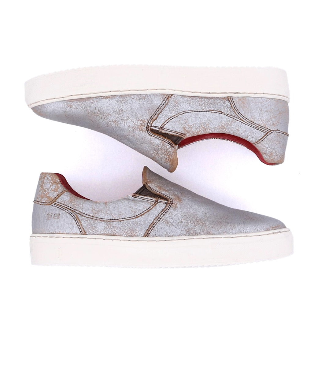 A pair of Hermione slip on sneakers with red soles made by Bed Stu.