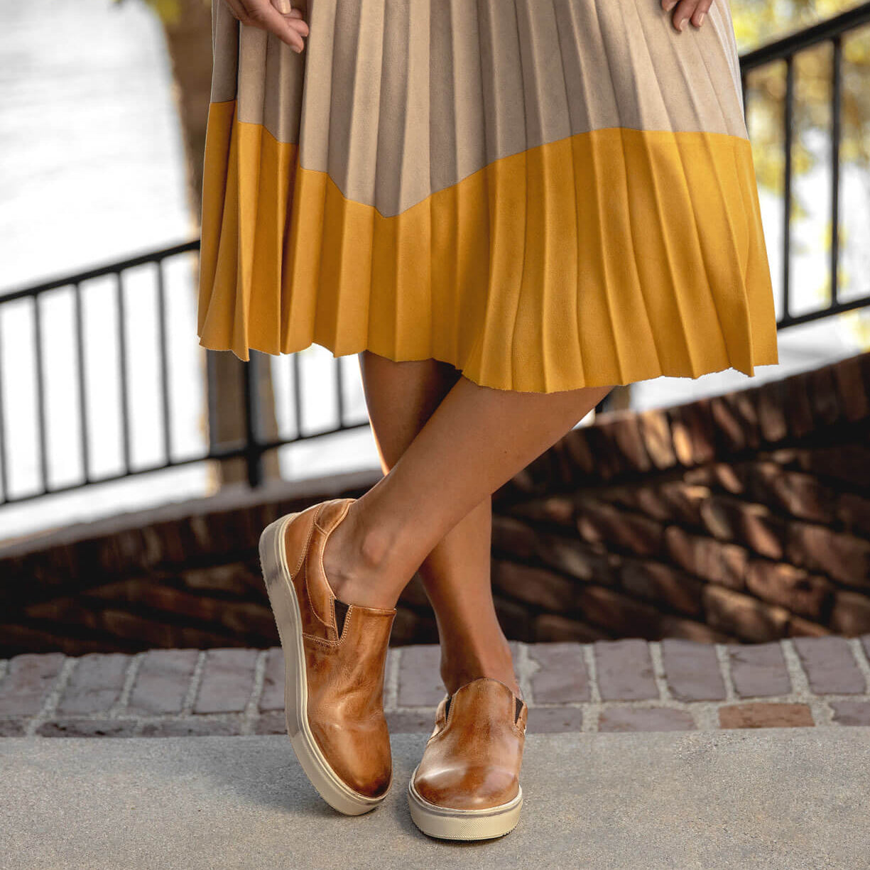 A woman wearing a Hermione pleated skirt and Bed Stu brown shoes.