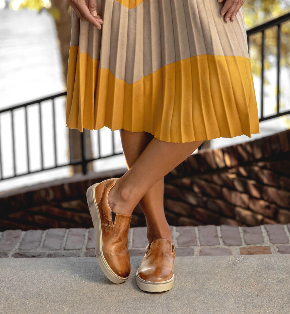 A woman wearing a Hermione pleated skirt and Bed Stu brown shoes.