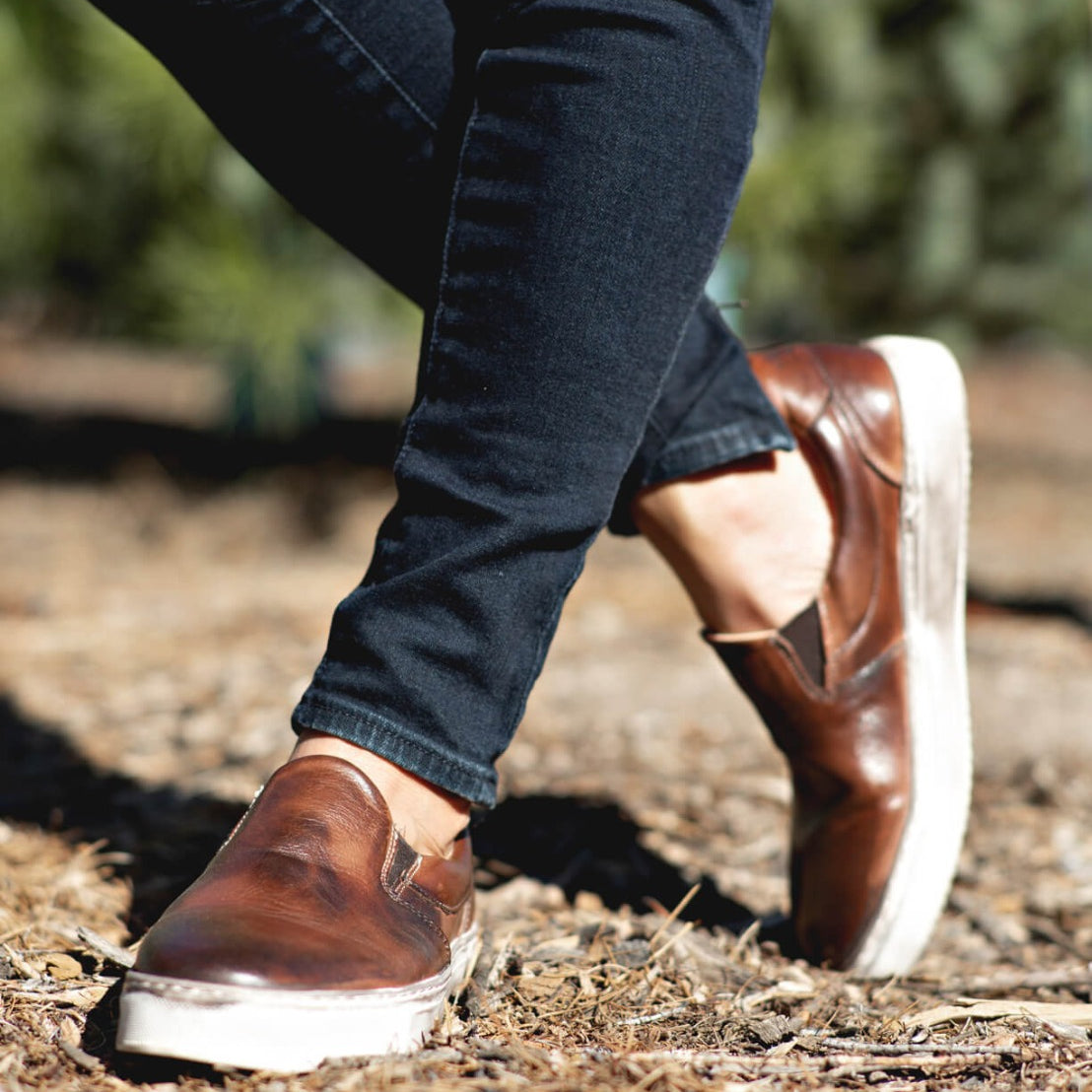 A woman wearing a pair of Bed Stu Hermione slip on shoes.