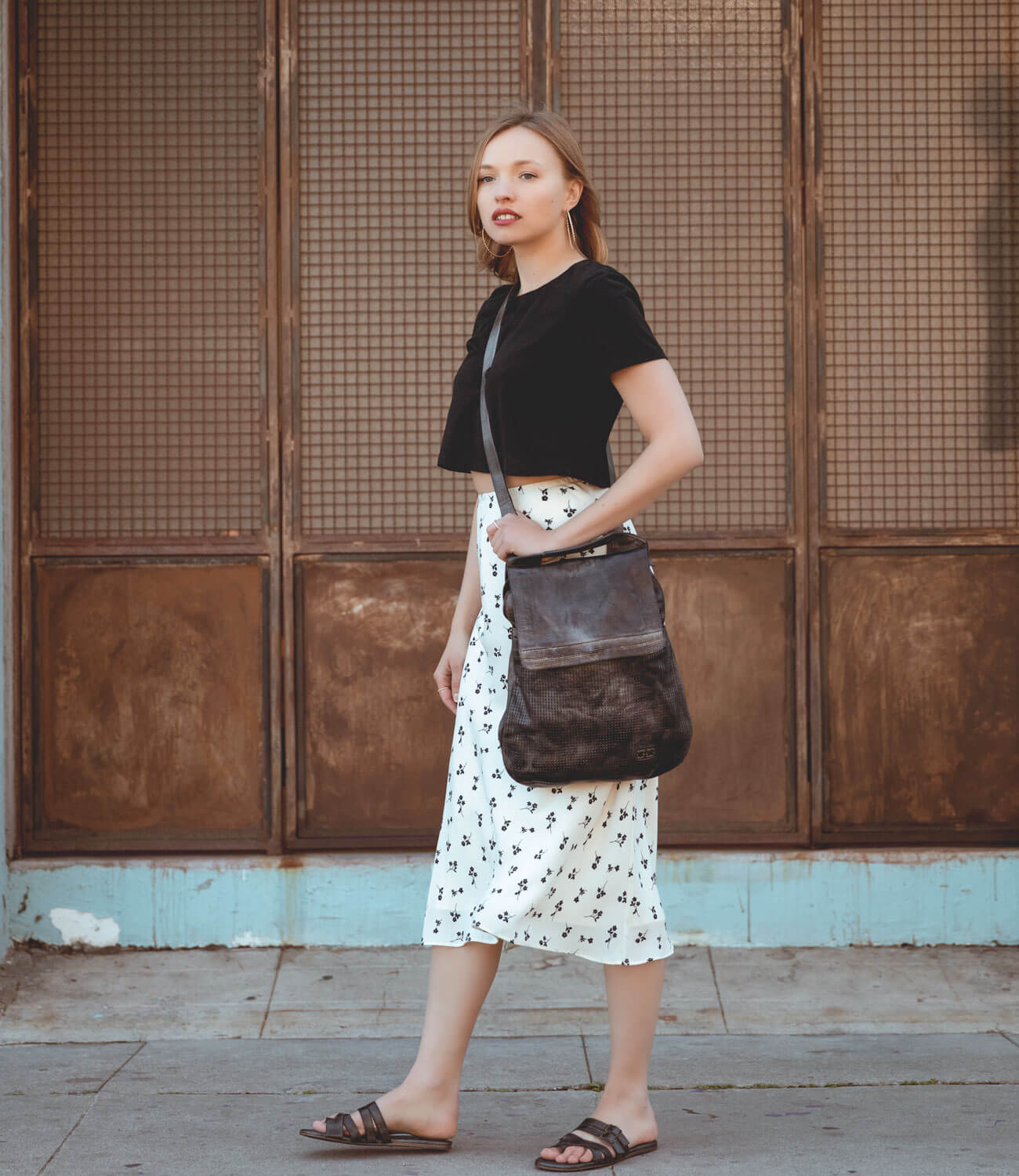 A woman wearing a Bed Stu Hilda sandals.