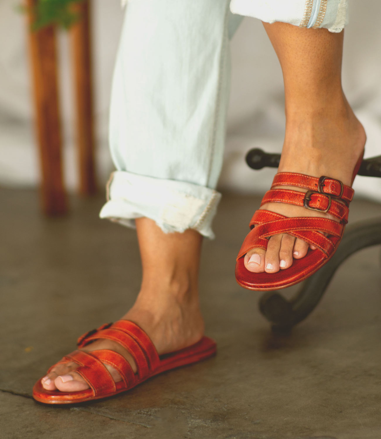 A woman in orange Bed Stu Hilda sandals.