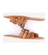 A pair of Bed Stu Holland tan sandals with buckles and white soles.