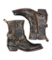 Bed|Stü “Homage” boots—distressed brown leather with square toes, side zippers, buckled harness straps, and low stacked heels—are shown from the side and sole against a white background.