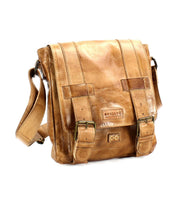 The Bed Stu Hue is a tan leather messenger bag designed for all genders, featuring a flap closure secured by two buckles, an adjustable shoulder strap, and multiple compartments.