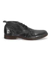 A single black leather Illiad dress shoe by Bed Stu, with a cushioned insole, displayed on a white background.