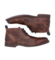 A pair of Bed Stu Illiad men's brown vegetable-tanned leather lace-up boots, displayed with one boot slightly above the other against a white background.