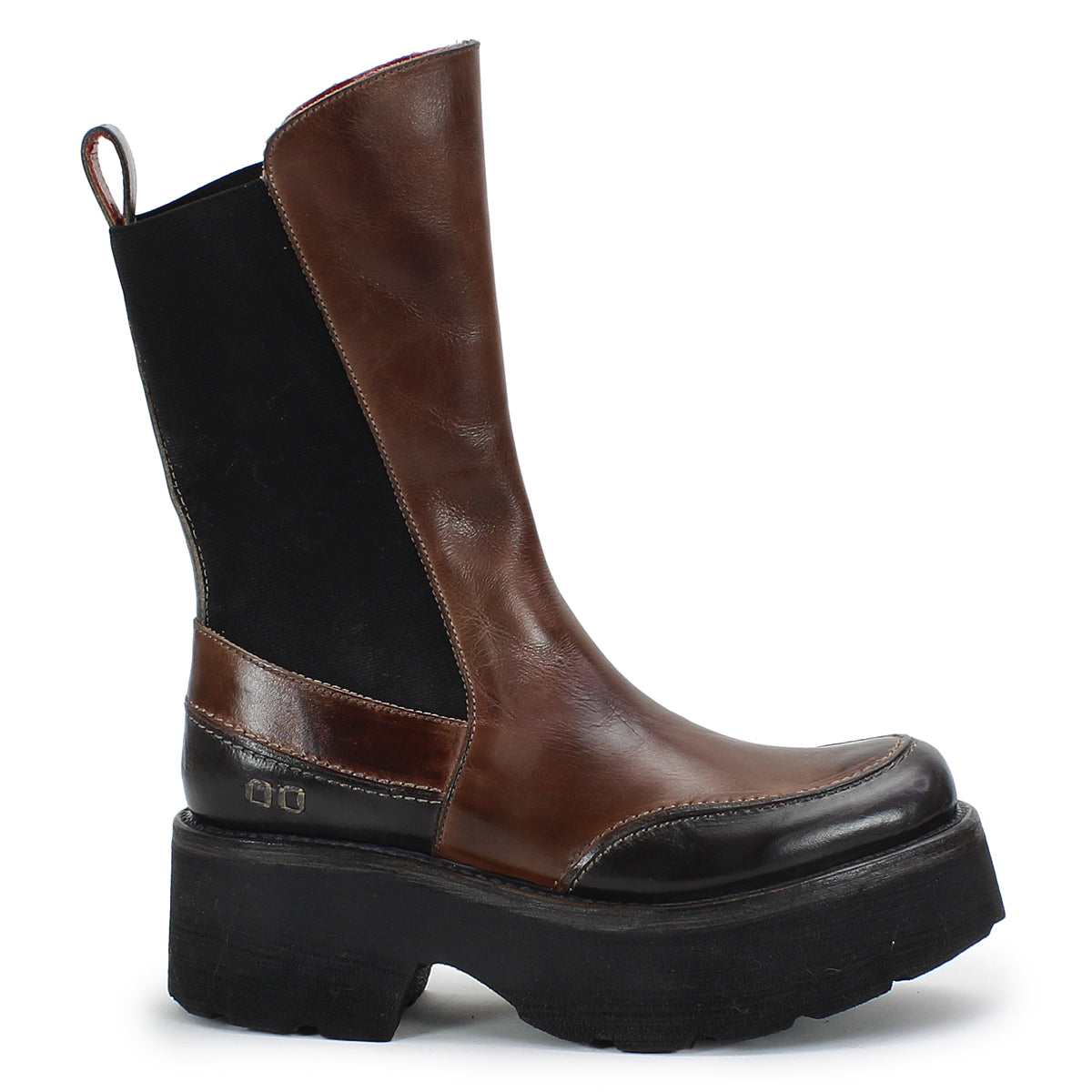 The Illicit boot by Bed Stu features a brown and black leather design, enhanced with a thick, chunky platform sole and a convenient pull tab on the back, delivering a nostalgic fashion vibe with retro flair.
