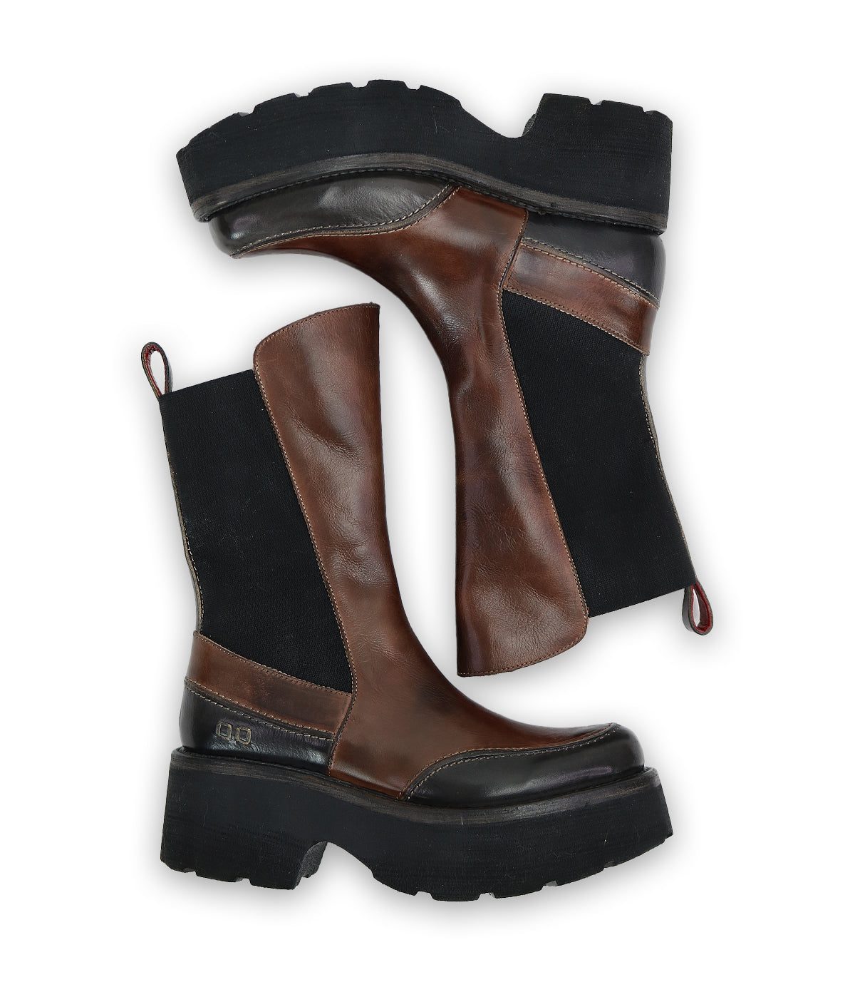 A pair of Bed Stu's Illicit platform boots, featuring brown leather and black fabric with chunky soles and a nostalgic fashion vibe, positioned sideways against a white background.