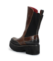 The Illicit ankle boot by Bed Stu, featuring a brown and black leather chunky platform with a thick heel viewed from the side, exudes retro flair and nostalgic fashion.