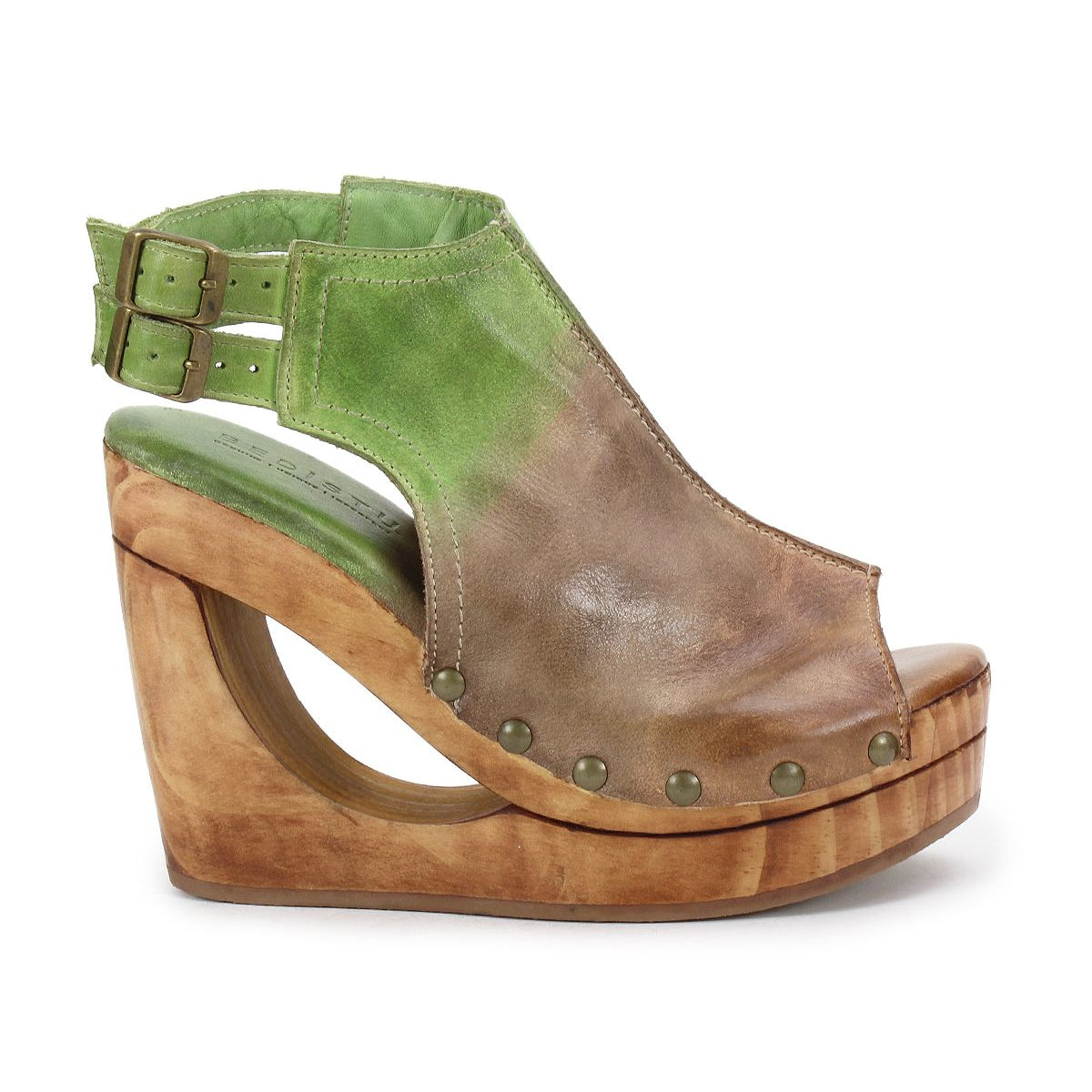 The Imelda by Bed Stu is a green and brown open-toe wedge sandal featuring a wood-effect platform, distinctive cutout heel, ankle strap, and rivet details.