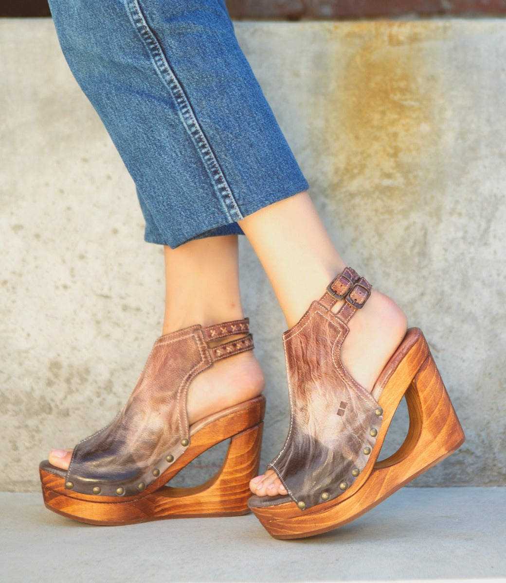 A woman wearing a pair of Bed Stu Imelda wooden wedges.