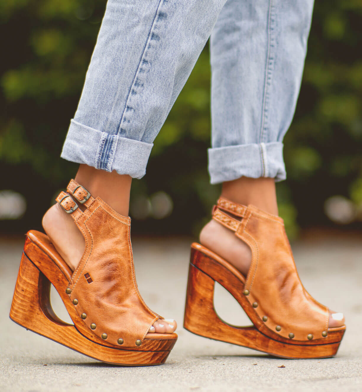 A woman wearing a pair of Imelda wooden platform sandals by Bed Stu.