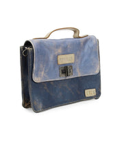 The Improv by Bed Stu is a worn blue leather satchel featuring a top handle and metal latch. The front displays a label with the word "beautiful" and includes a smaller side compartment. Combining fashion with functionality, it comes equipped with a detachable crossbody strap. The leather exhibits signs of use and discoloration.