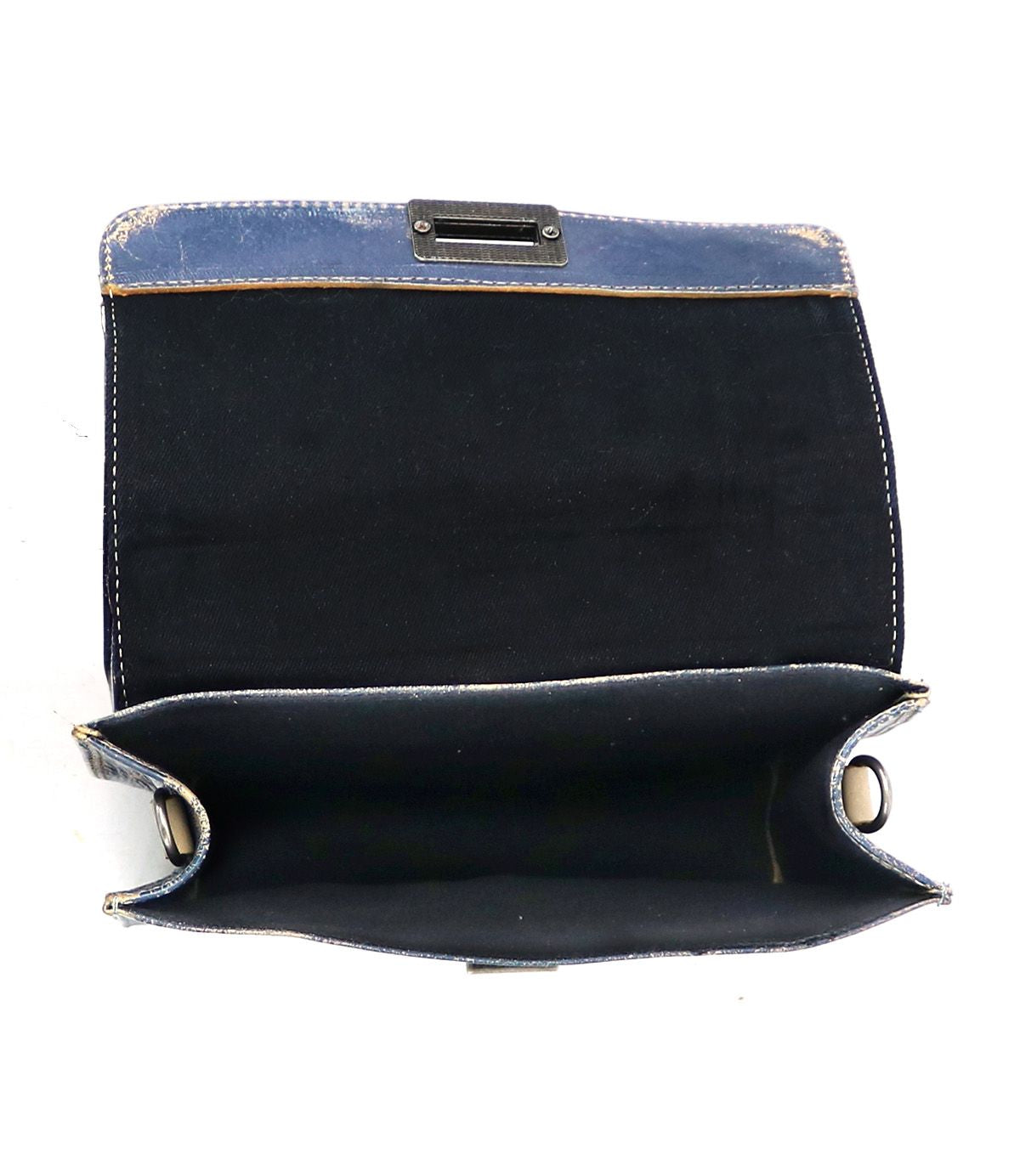 An open, blue fabric clutch purse from Bed Stu's Improv line, featuring visible wear and scuff marks. The black, empty interior offers a glimpse of its past fashion and functionality.