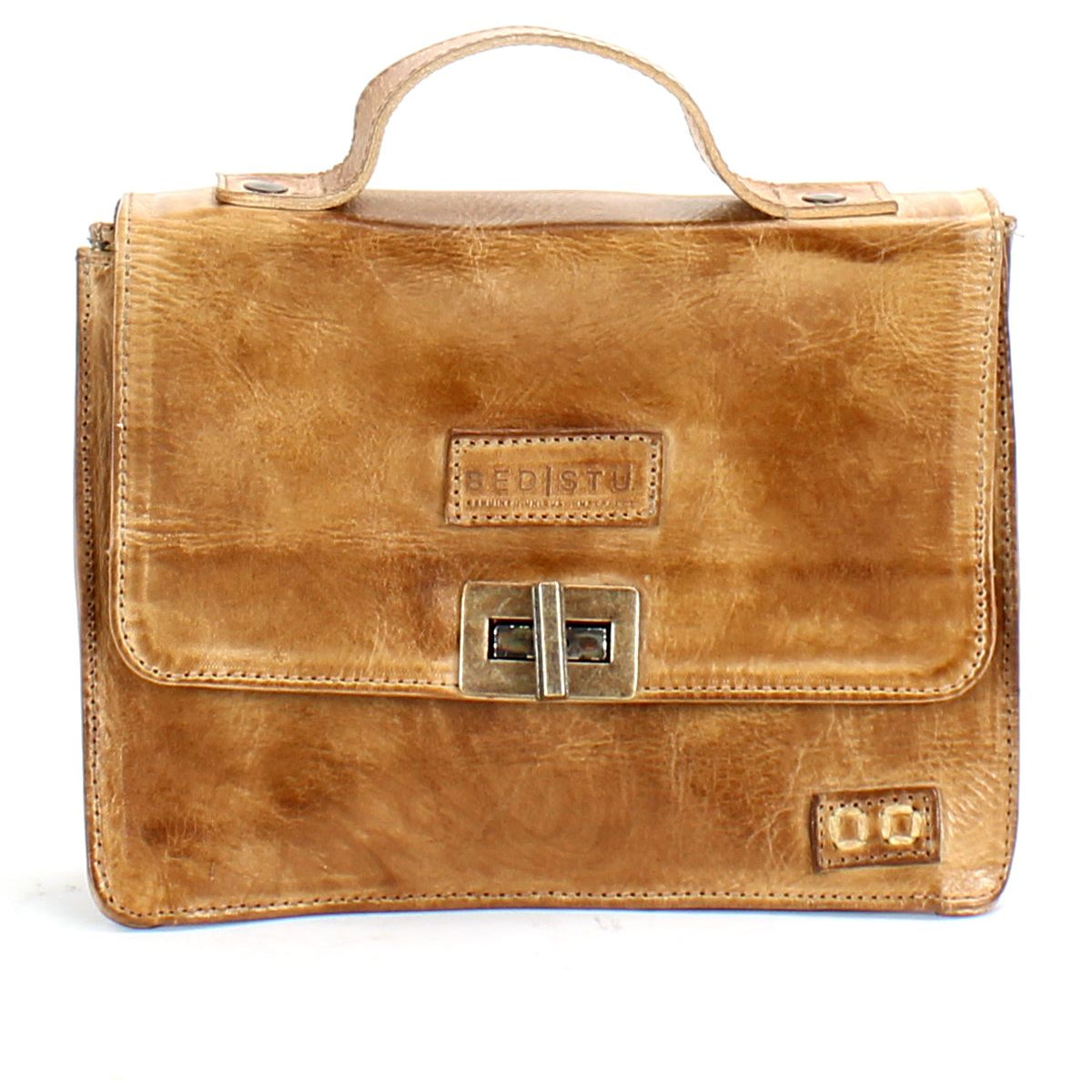 The Improv by Bed Stu is a brown leather satchel featuring a top handle, front buckle clasp, embossed brand name on the flap, and a handy crossbody strap for added fashion and functionality.