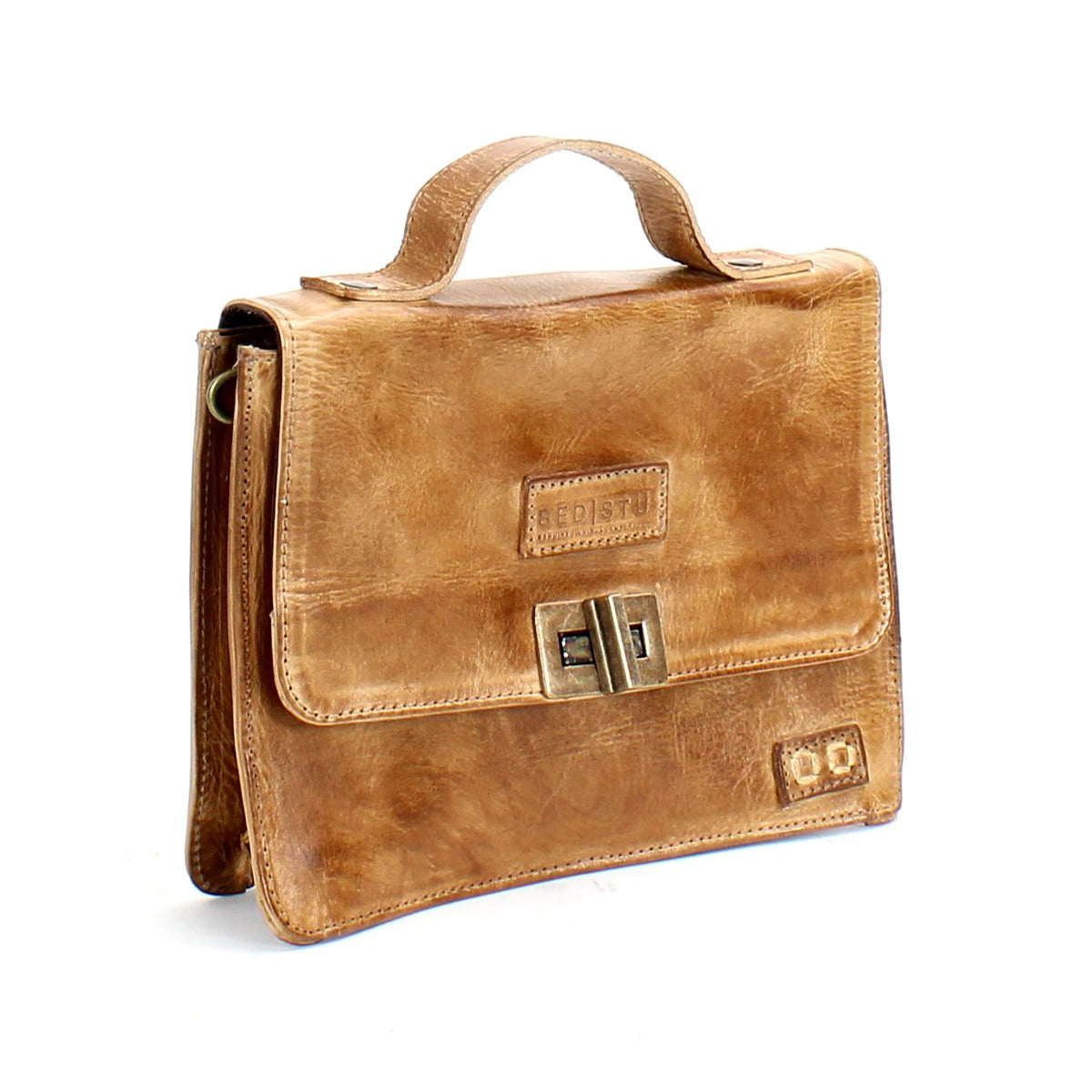 A brown leather briefcase with a handle on top, a clasp closure on the front, and the brand name "Bed Stu" embossed on the front flap. Combining fashion and functionality, this briefcase, named the Improv, also features an optional crossbody strap for added convenience.