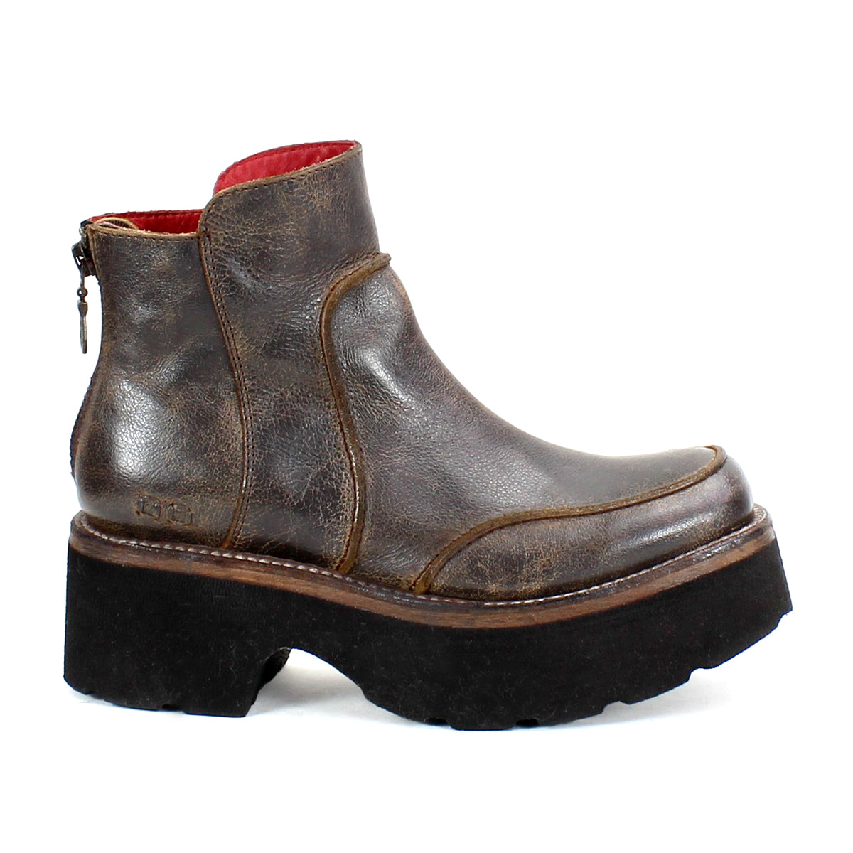 The Infamy by Bed Stu is a brown leather ankle boot with a back zipper, highlighted by a chunky black platform sole. This striking platform boot design is enhanced with high-quality leather finishes, providing both style and durability for any fashion-forward wardrobe.