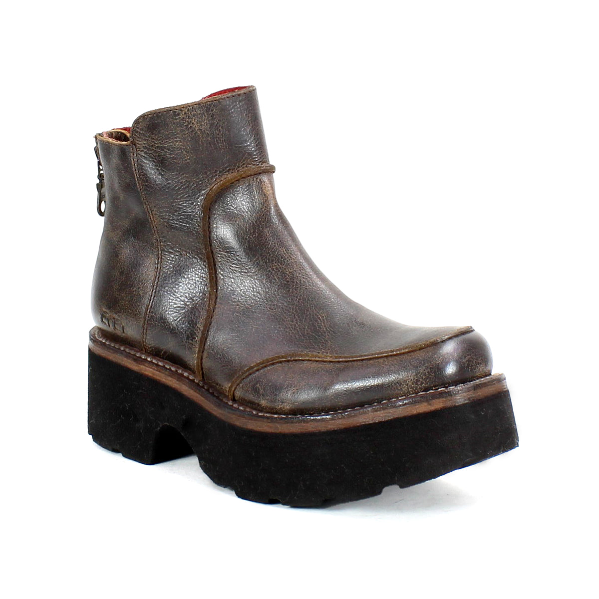 The "Infamy" by Bed Stu is a brown leather platform boot, accented with a chunky outsole and a back zipper, beautifully showcased against a plain white background.