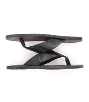 A pair of comfortable Bed Stu black flip flops on a white background.