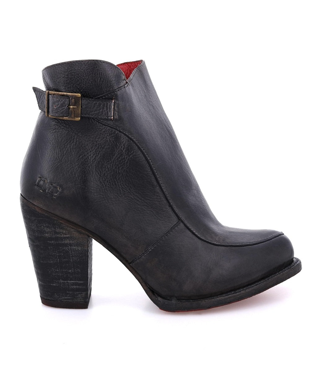 The Isla by Bed|Stü is a black heeled bootie crafted from smooth leather, featuring a thick high heel, a side buckle detail reminiscent of an ankle strap, and a striking red inner lining, pictured in profile on a white background.
