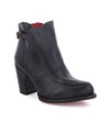 An Isla black ankle boot with a red heel made by Bed Stu.