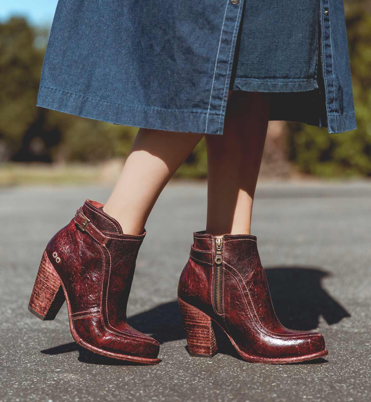 A woman wearing a Bed Stu Isla ankle boots with a denim dress.
