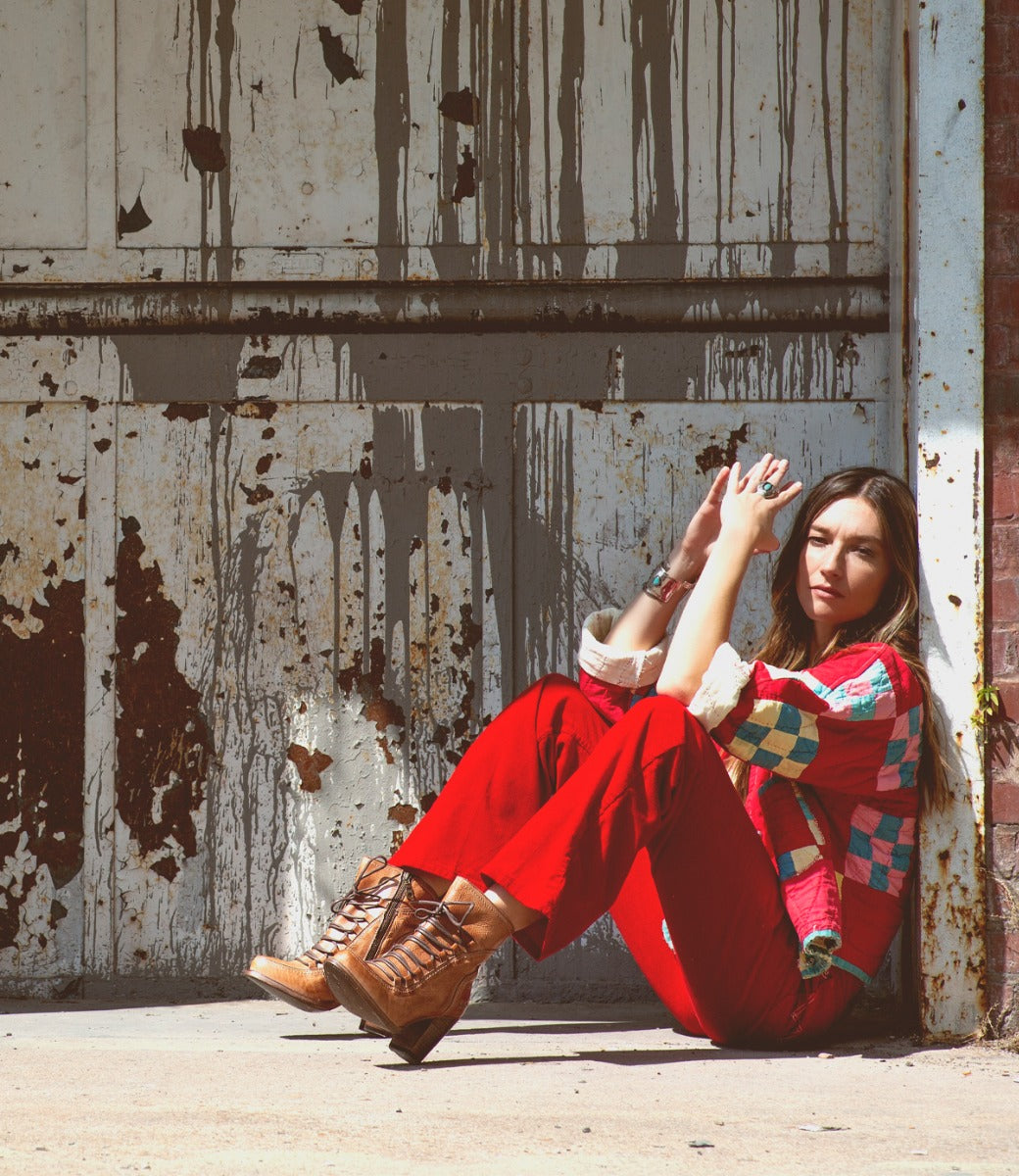 A woman sitting in front of an Izetta by Bed Stu door.