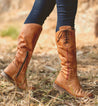 A woman wearing a pair of Bed Stu Janina tan leather boots.