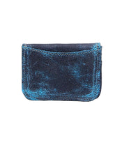 The Jeor wallet by Bed Stu is a rectangular, dark blue accessory with a weathered appearance and light blue distressed accents. It features a single pocket and a rustic leather card holder.