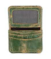 The Bed Stu Jeor is a rustic leather card holder in worn green with visible scuffs. This compact wallet has a clear ID window and two credit card slots, shown open and empty.