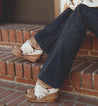 A woman wearing jeans and a pair of Bed Stu Jessie cowboy boots.