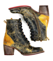 A pair of worn Bed Stu Judgement boots, featuring a black and yellow color scheme, 8-eye lace-up design, side zippers, wooden heels, and cushioned insoles, photographed against a white background.