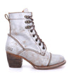 A women's silver ankle boot with a wooden heel, called Judgement by Bed Stu.
