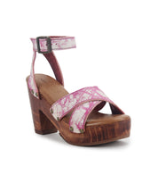 The Kalah sandal by Bed Stu blends timeless elegance with a floral design, featuring a pink platform, sustainably sourced wooden wedge heel, and an ankle strap with a metal buckle.