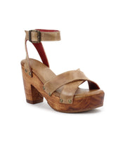 The Kalah by Bed Stu is a brown leather platform sandal with a sustainably sourced wooden block heel, featuring an ankle strap and rivet detailing.