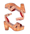 A pair of Bed Stu Kalah wooden sandals with red straps.
