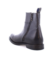 The Kaldi handmade leather boot by Bed Stu, featuring a side zipper, is shown from the back and slightly to the side, highlighting its classic silhouette.