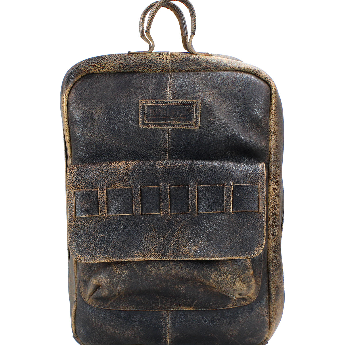 A worn, handcrafted leather backpack with a single top handle, a front pocket, and a label patch above it made from vegetable-tanned leather. The Kamet by Bed Stu.