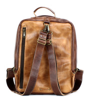 A handcrafted brown leather Kamet with a top handle, two shoulder straps, a side zipper pocket, and brass hardware accents by Bed Stu.