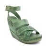 A women's green Bed Stu wedge sandal with straps and buckles.