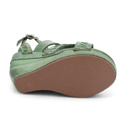 A pair of green Bed Stu sandals with straps and buckles.