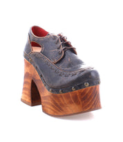 A single Bed Stu Karaoke vintage brown leather shoe, featuring chunky wooden platform heels and metal stud accents that evoke the 70s era, set against a white background.