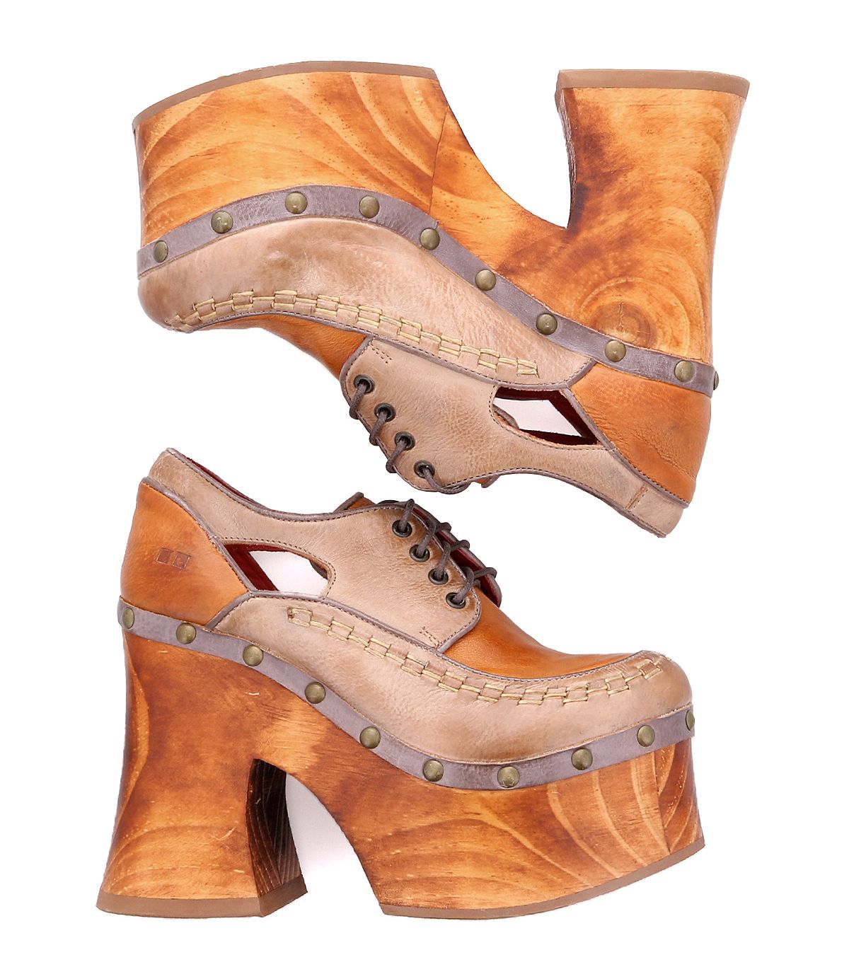 A pair of Bed Stu Karaoke stacked, tan leather platform shoes featuring chunky wooden heels and decorative metal studs, evoking a vibrant 70s era aesthetic.