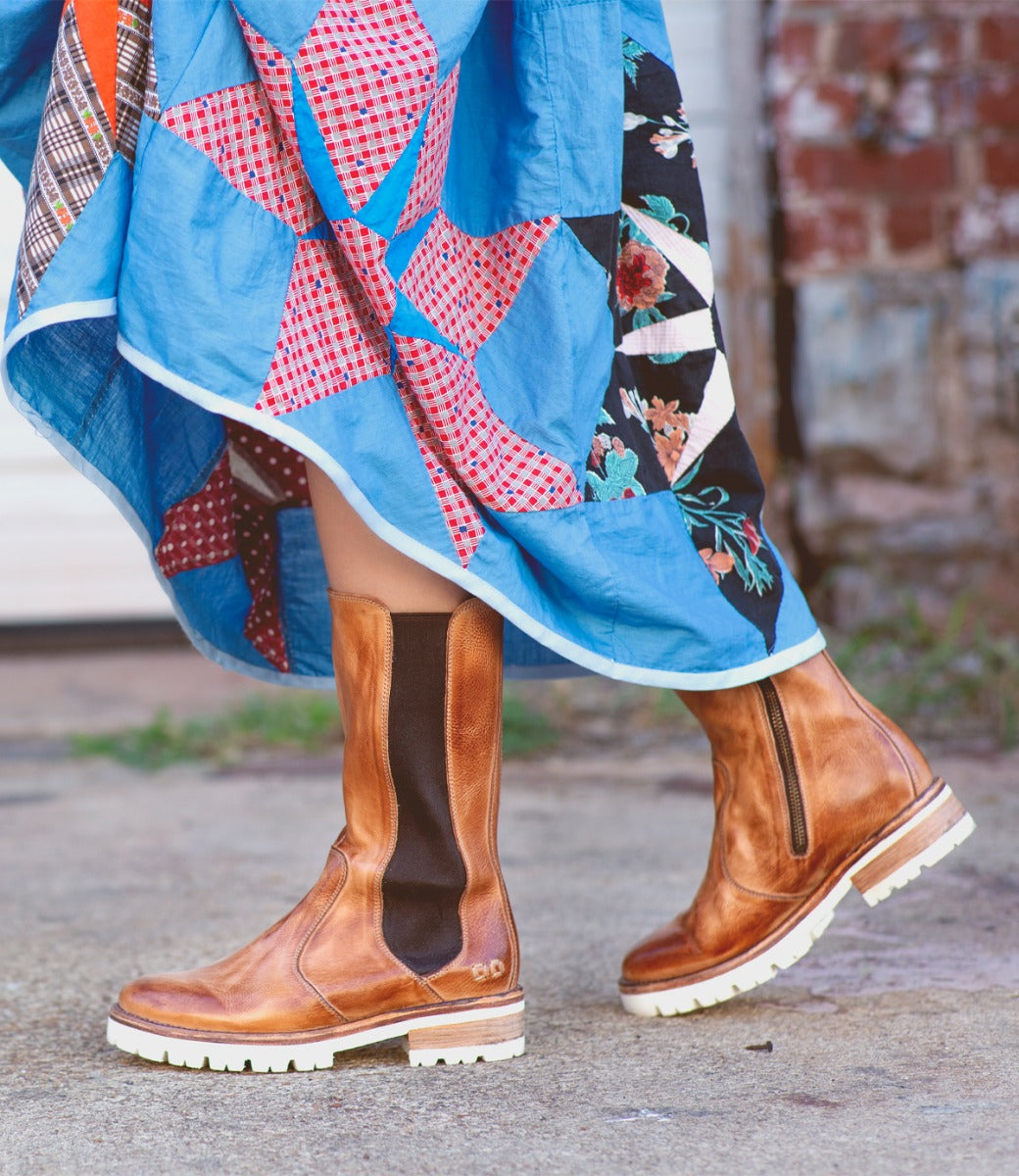 A woman wearing a dress and Kataleya boots by Bed Stu.